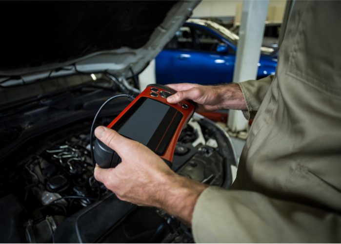 hands mechanic using diagnostic tool